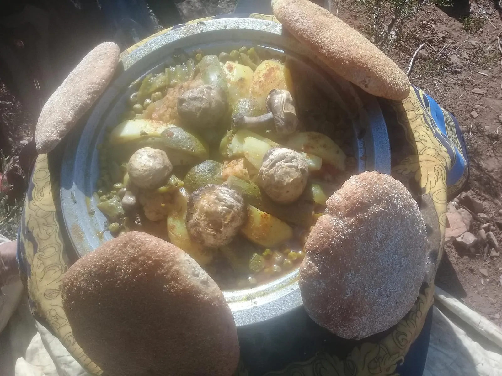 Le tajine ouvert, pains ronds tout autour du plat